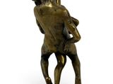 bronze statue of a man holding a woman on his back