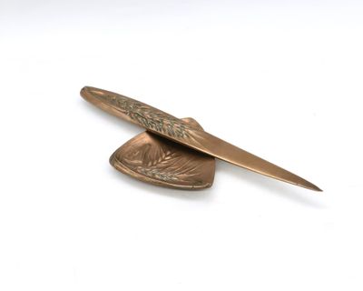 a knife and a spoon sitting on top of a piece of metal