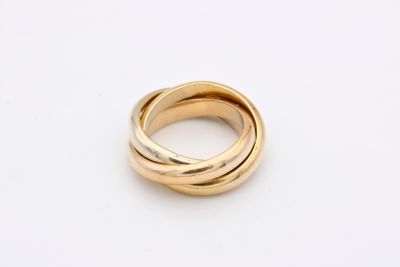 a close up of a gold ring on a white surface