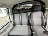 two seats in the back of a van with a dog sitting in the passenger seat