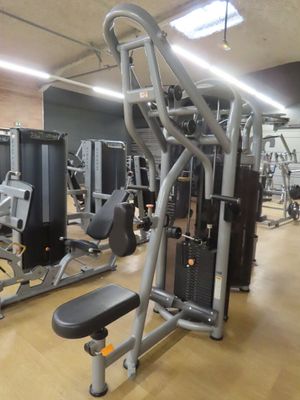 a gym room with a variety of machines in it