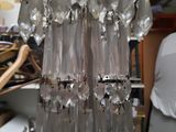 a glass chandelier hanging from a ceiling in a room