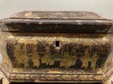 a black and gold box with a picture of elephants on it