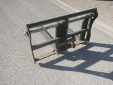 an image of a skid steer on the side of the road