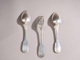 three silver spoons and a fork on a white surface
