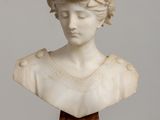 marble bust of a woman with a wreath of flowers on her head