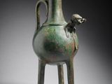 an image of a green vase with a monkey on the handle