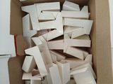 a cardboard box filled with white boxes on top of a table