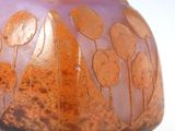purple and orange vase with trees on it on a white surface