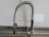 a kitchen sink with a faucet and a bottle in it