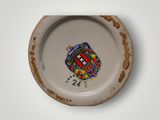 a small plate with a coat of arms on it