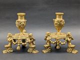 pair of antique brass candlesticks with cherenshes and cherenshes