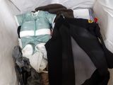 a pile of clothes in a bag on the floor