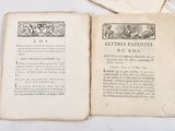 three old books sitting on a table with one open