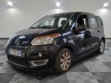 the small black van is parked on a checkered tile floor