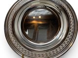an image of a silver plate with a mirror in the middle of it
