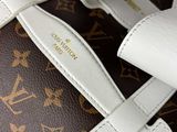 a close up of a louis vuitton bag on a table