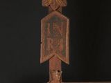 a close up of a metal cross with a cross on it ' s side