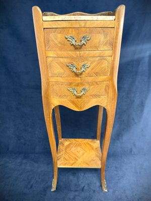 a wooden chest of drawers with a shelf on top of it