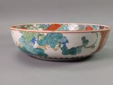 a bowl with a floral design on it on a gray surface