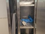 a stainless steel cabinet with a door open in a room