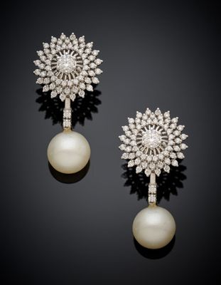 a pair of pearl and diamond earrings