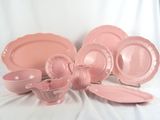 pink dishes and cups on a white background