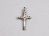 silver cross with a black stone in the center on a white background