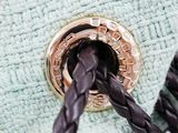 a close up of a purse with a braid handle