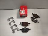 a box of brake pads and a pair of brake pads on a table