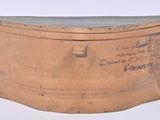 a wooden box with writing on it on a white surface