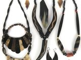 several pieces of jewelry are displayed on a white surface