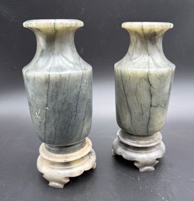 two vases that are sitting next to each other on a table