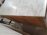 a white marble counter top with a wooden base