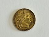 a close up of a gold coin on a white surface