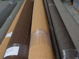 many rolls of brown fabric on the floor