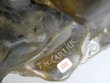 a close up of a statue of a dog with a tag on it ' s collar