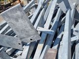 many pieces of metal sitting on the ground next to each other