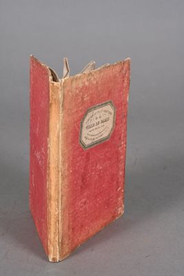 a small red book with a white label on it