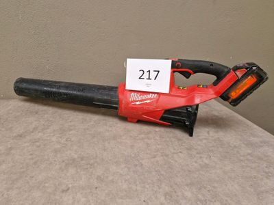 a red and black corded blower sitting on top of a table
