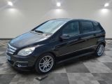 the mercedes b - class is parked in a garage with a checkered floor