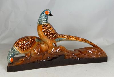 two birds that are sitting on a wooden block