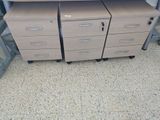 two desks with drawers and a computer on top of them