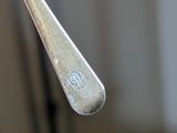 a spoon with a fork sticking out of it