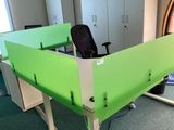 un bureau vert avec une chaise noire dans une pièce