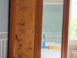 an image of a bedroom with blue walls and a wooden armoire