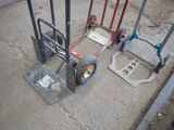 a dolly with wheels and a wheelbarrow on the ground