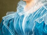 portrait of a woman in a blue dress with a white lace collar
