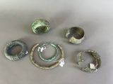several pieces of metal are arranged on top of a table