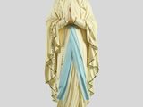 La statue de la Vierge Marie se dresse sur un rocher.